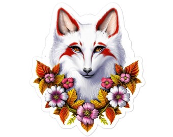 May include: A white fox with red markings around its eyes and mouth, surrounded by a wreath of pink and yellow flowers and autumn leaves.