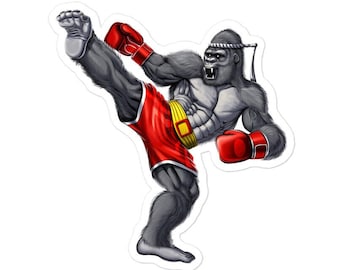 May include: A gray gorilla wearing red boxing gloves and red shorts with a yellow waistband, kicks with its right leg in a Muay Thai fighting pose.