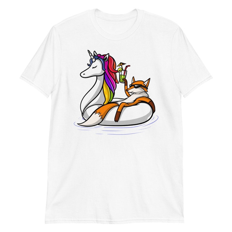 May include: A white t-shirt with a graphic of a fox wearing sunglasses and holding a drink, relaxing on a unicorn pool float.