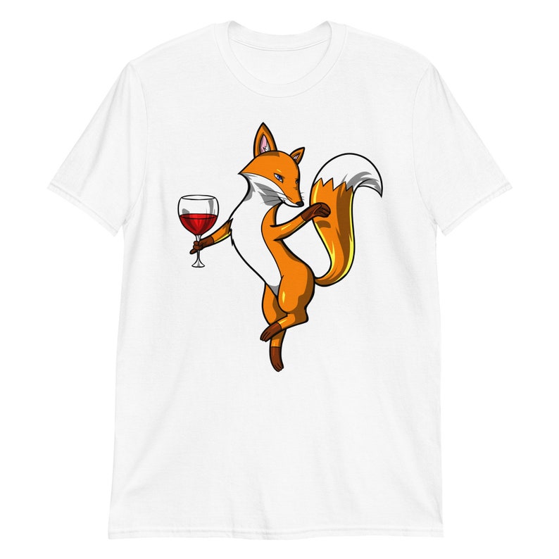 May include: A white t-shirt with a cartoon fox holding a glass of red wine. The fox is orange and white with a bushy tail.