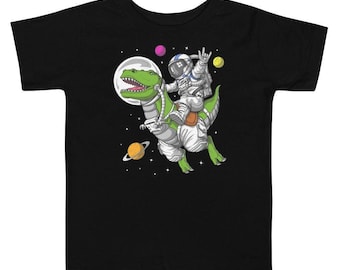 Camiseta infantil de dinossauro T-Rex montado em astronauta espacial - Camisetas engraçadas de dinossauro para crianças - Camiseta para meninos com dinossauro - Roupas de dinossauro - Roupas de dinossauro