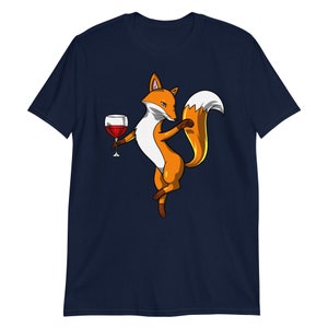 May include: A navy blue t-shirt with a cartoon fox holding a glass of red wine. The fox is orange and white with a bushy tail.
