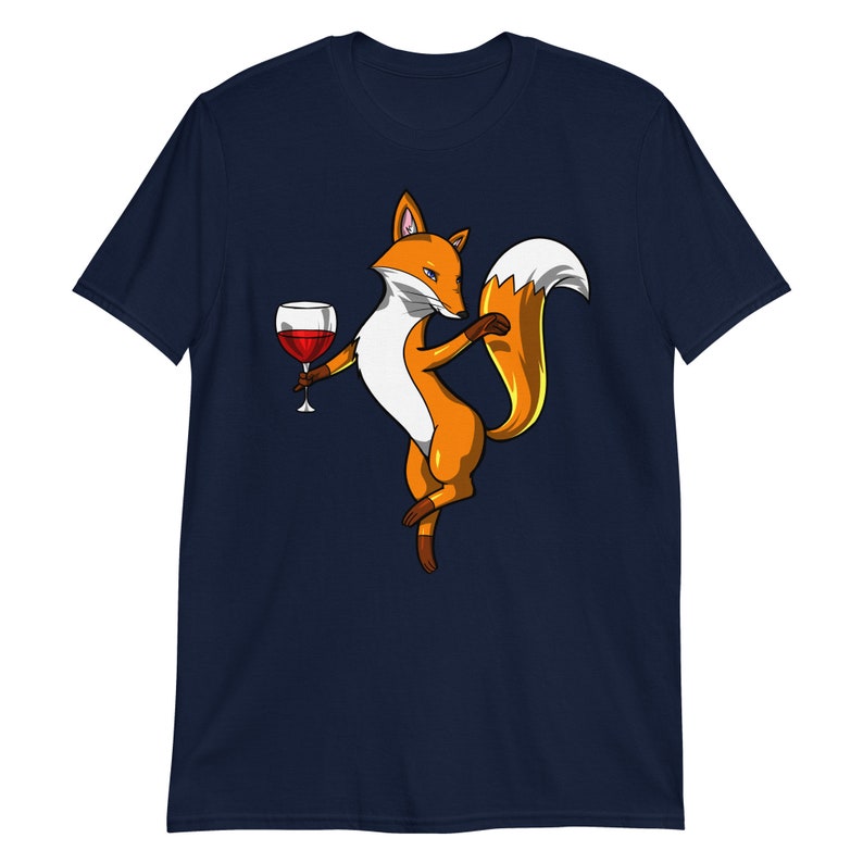 May include: A navy blue t-shirt with a cartoon fox holding a glass of red wine. The fox is orange and white with a bushy tail.