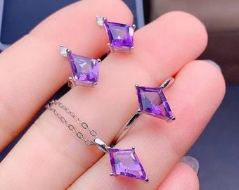 May include: A set of amethyst jewelry featuring a necklace, ring, and earrings. Each piece has a square-shaped amethyst gemstone with a silver setting.
