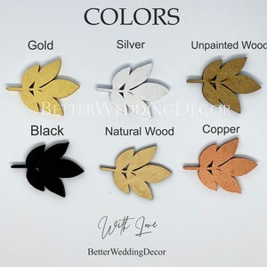 May include: A color chart displaying six leaf-shaped cutouts labeled Gold, Silver, Unpainted Wood, Black, Natural Wood, and Copper. The text BETTERWEDDINGDECOR and With Love BetterWeddingDecor are visible. Each leaf features a central stem and cutouts.