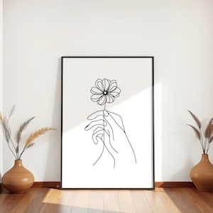 Mano con flor en arte lineal minimalista: dibujo botánico de una sola línea, impresión mural moderna en blanco y negro, póster digital simbólico