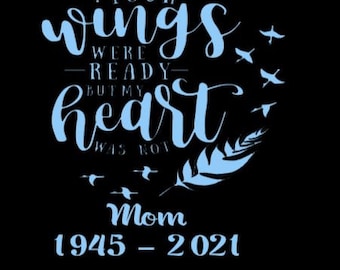 May include: Blue text on a black background reads "Your wings were ready but my heart was not. Mom 1945-2021".  The text is surrounded by a blue feather and small blue birds.