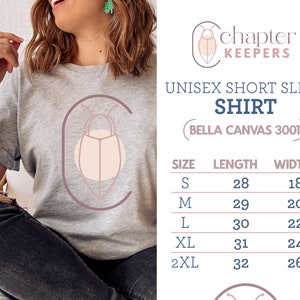 May include: Gray unisex short sleeve t-shirt with a graphic of a stylized beetle in a circle. The shirt is made by Bella Canvas and is available in sizes S-2XL. The size chart shows the length and width of the shirt in inches.