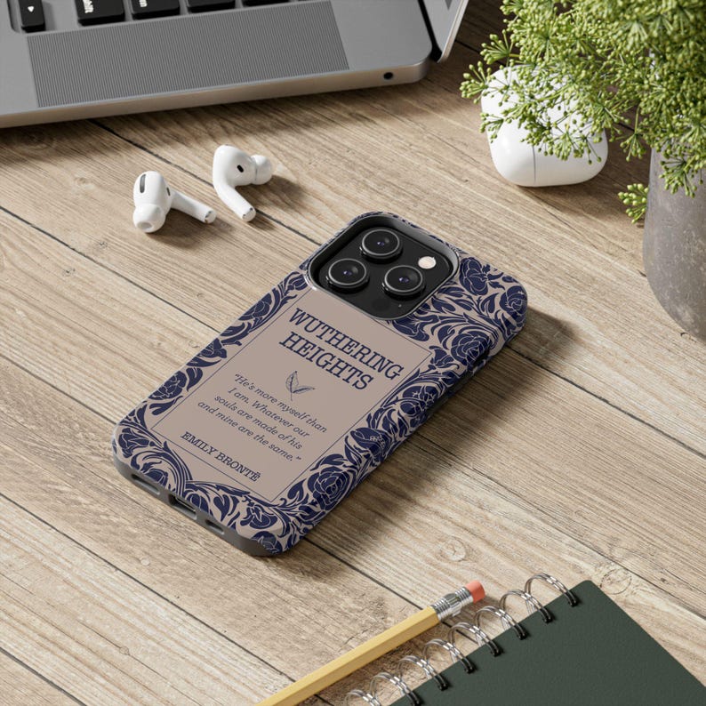 May include: A phone case with a design inspired by the classic novel "Wuthering Heights" by Emily Bront&euml;. The case features a floral pattern in shades of blue and white on a beige background. The title of the book is printed in black lettering.