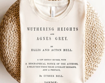 May include: A beige t-shirt with black text that reads "Wuthering Heights and Agnes Grey. By Ellis and Acton Bell. A new edition revised, with a biographical notice of the authors, a selection from their literary remains, and a preface, by Currer Bell. London:"