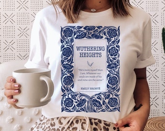 May include: White t-shirt with a blue graphic of the book cover for "Wuthering Heights" by Emily Brontë. The graphic features a floral design and the book title and author's name.