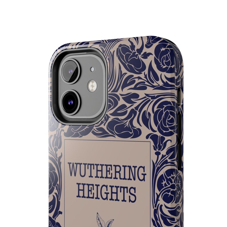 May include: A phone case with a beige background and a blue floral pattern. The case has a cutout for the camera lens and the text "Wuthering Heights" printed on the front.