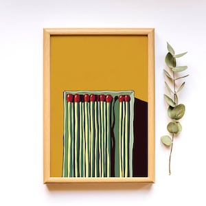 May include: A framed illustration of a box of matches with red tips and green and yellow stripes on a yellow background.