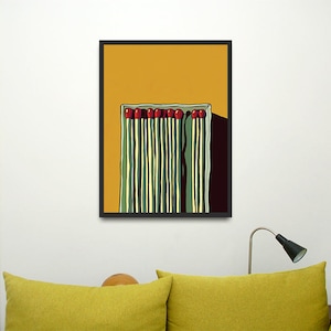 May include: A framed illustration of a box of matches with red tips on a yellow background.