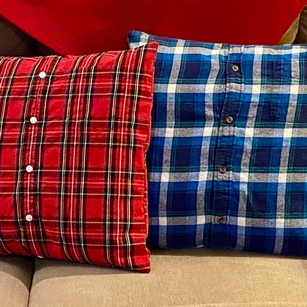 May include: Two decorative pillows made from repurposed plaid shirts. The pillow on the left is red and black plaid, and the pillow on the right is blue and white plaid.