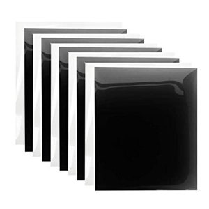 Puede incluir: Un conjunto de siete láminas de vinilo termoadhesivo negro con respaldo blanco. Las láminas están apiladas unas sobre otras.