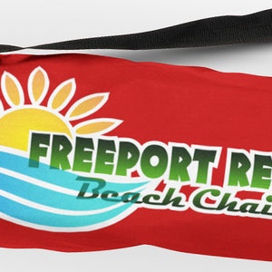 May include: Red carrying case with a black strap and a logo that says "Freeport Resort Beach Chairs" with a sun and waves graphic.