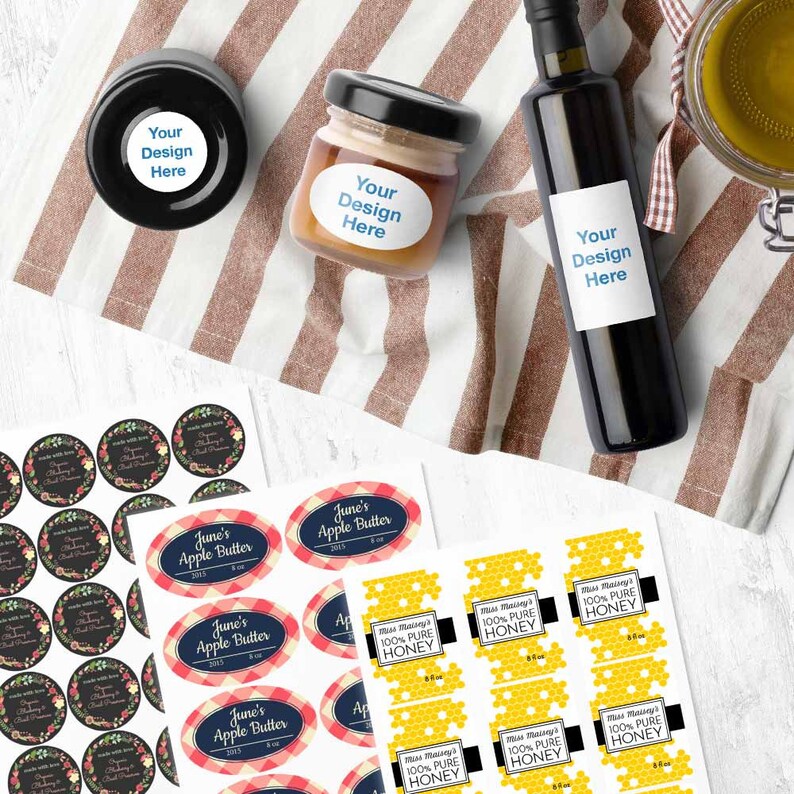 May include: A set of labels for jars and bottles. The labels are printed with a variety of designs, including floral patterns, gingham patterns, and honeycomb patterns. The labels are also printed with text, such as "June's Apple Butter" and "Miss Maisie's 100% Pure Honey".