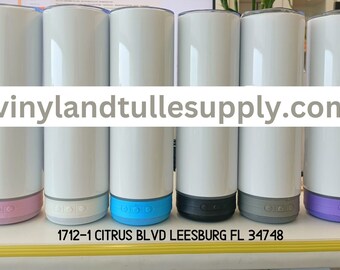 May include: Six white sublimation tumblers with different coloured bases. The bases are pink, white, blue, black, grey, and purple. The tumblers are all the same size and shape. The text "vinylandtulle supply.com" is printed on the image. The text "1712-1 CITRUS BLVD LEESBURG FL 34748" is printed below the tumblers.