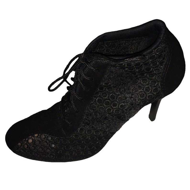 May include: Black lace ankle boots with a high heel. The boots have a lace-up front and a pointed toe.