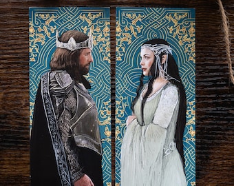 May include: Two bookmarks featuring illustrations of a king and queen. The king is wearing a crown and armor, while the queen is wearing a white gown and a crown. The background is a teal blue with gold floral patterns.
