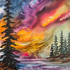 May include: Abstract watercolor painting of a landscape with a vibrant sunset. The sky blends shades of pink, orange, and yellow, with dark green trees and a body of water in the foreground. The artist's signature is in the bottom right corner.