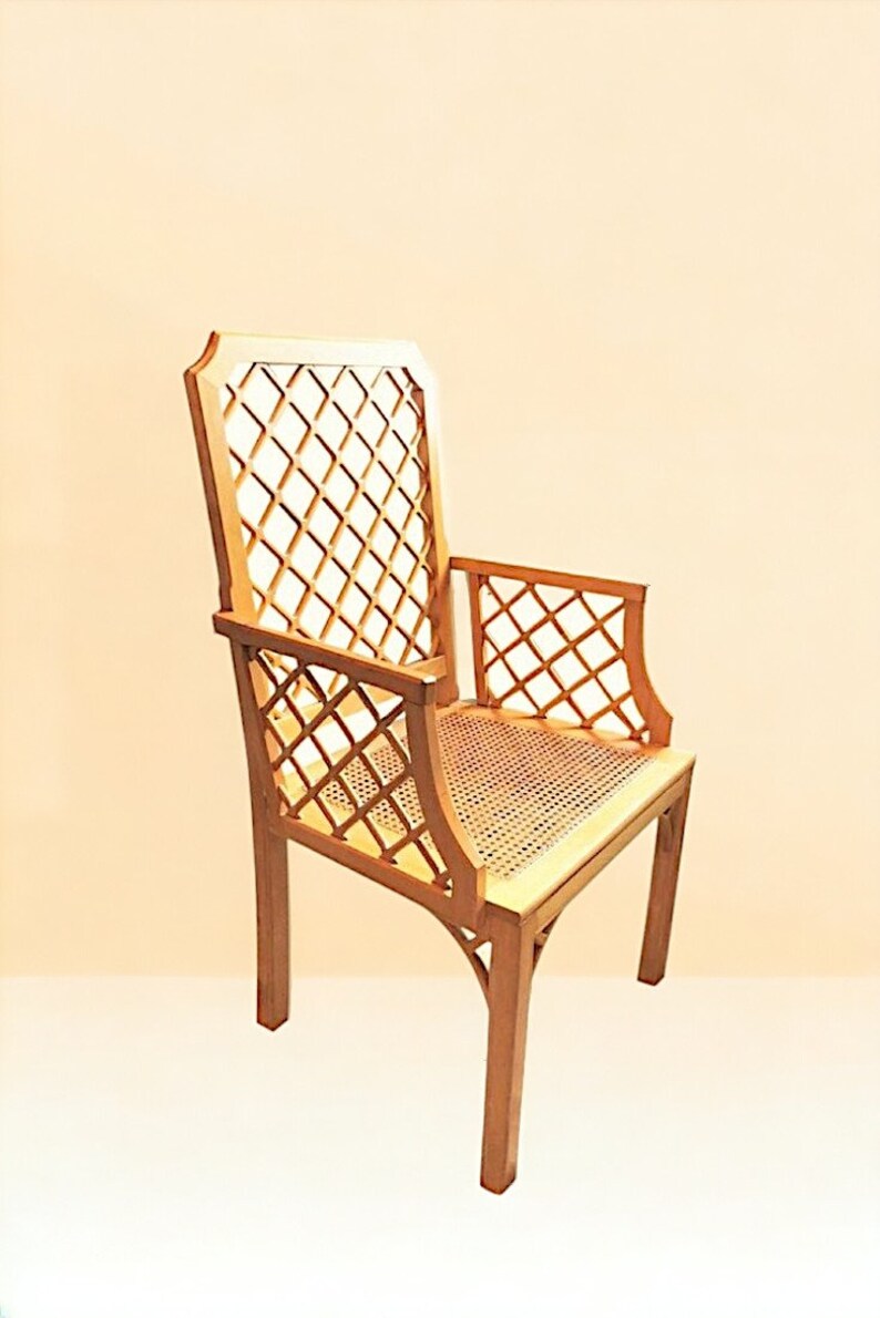 May include: A wooden chair with a lattice back and seat. The chair is made of light brown wood and has a simple, elegant design.
