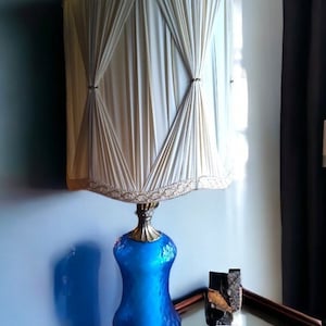 VINTAGE elegance meets Mid Century charm in a blue glass lamp Iconic Mid Century Modern design Retro-chic blue glass lighting