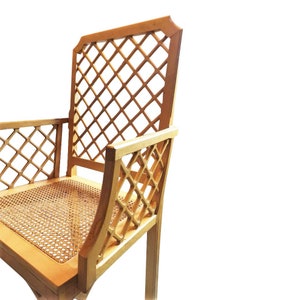 May include: A wooden chair with a lattice back and seat. The chair is made of light wood and has a woven cane seat.