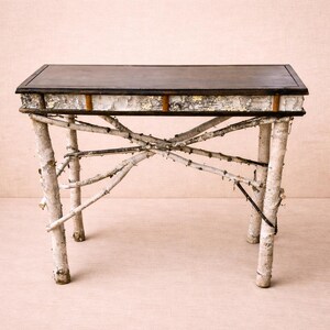 May include: A rectangular console table featuring a dark brown wooden top and a frame constructed from natural white birch logs. The apron is accented with birch bark, and the four legs are connected by crossed branch supports.