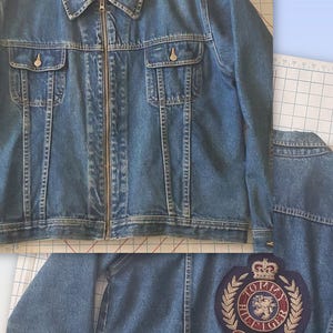 May include: A blue denim jacket with a zip-up front, two chest pockets, and two side pockets. The jacket has a collar and buttoned cuffs. The Tommy Hilfiger logo is visible on the inside collar and on a patch on the back.