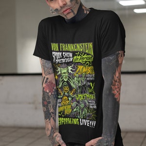 May include: Black t-shirt with a green and black graphic print of a spooky show featuring Von Frankenstein, Zombies, Wolfman, and other monsters. The text reads "Von Frankenstein Spook Show Spectacular In Person Performing Live!"