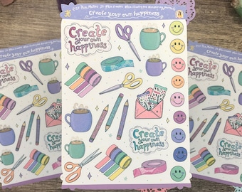 May include: Three sheets of stickers with a purple border and a white background. The stickers feature illustrations of coffee cups, scissors, pencils, washi tape, and smiley faces. The text "Create your own happiness" is repeated on each sheet.