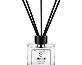 May include: A clear glass reed diffuser bottle with a black cap and five black reeds. The label features the text Affirmation Effect, AE, Blessed, Egyptian Amber, REED DIFFUSER, and NET WT. 4OZ (113G) inside a decorative rectangular border.