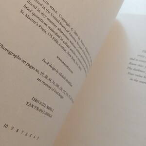 May include: A white ceramic mug with a black handle and the text "But First, Coffee" in a black, bold font. The mug is on a white surface. The mug is approximately 4 inches tall.