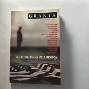 May include: A magazine cover with the title "GRANTA: THE MAGAZINE OF NEW WRITING/77" and a folded American flag. The cover features the text "WHAT WE THINK OF AMERICA" and lists several authors including Hanan al-Shaykh, Amit Chaudhuri, Ariel Dorfman, Lu Gusun, Aleksa Djilas, James Hamilton-Paterson, Michael Ignatieff, Ivan Klíma, David Malouf, Fintan O'Toole, Orhan Pamuk, Karim Raslan, Ahdaf Soueif, and many more.