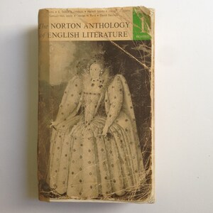 May include: A vintage book cover with a worn, yellowed appearance. The cover features a black and white image of a woman in a patterned dress and a large, ruffled collar. The title of the book is "The Norton Anthology of English Literature" with the word "REVISED" in green text.