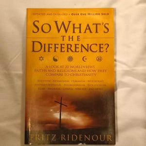 May include: A yellow book cover with the title "So What's the Difference?" and a subtitle "A look at 20 worldviews, faiths and religions and how they compare to Christianity". The cover also features a cross and the author's name, Fritz Ridenour.