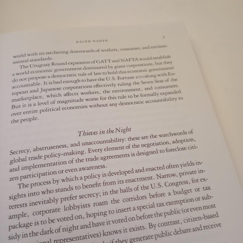May include: A page from a book titled "Thieves in the Night" by Ralph Nader. The text discusses the secrecy and unaccountability of global trade policy-making. The text highlights how trade agreements are designed to exclude citizen participation and awareness.
