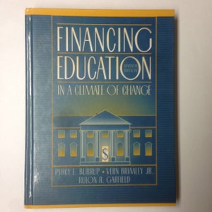 May include: A blue book with the title "Financing Education: In a Climate of Change" on the cover. The book is the seventh edition and features a drawing of a building with a dollar sign in front of it.