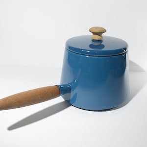 May include: A blue enamel saucepan with a wooden handle and lid. The lid has a wooden knob.