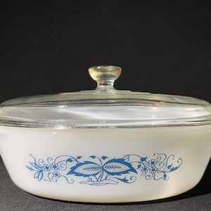 May include: White oval baking dish with a glass lid. The dish has a blue floral design with leaves and flowers.