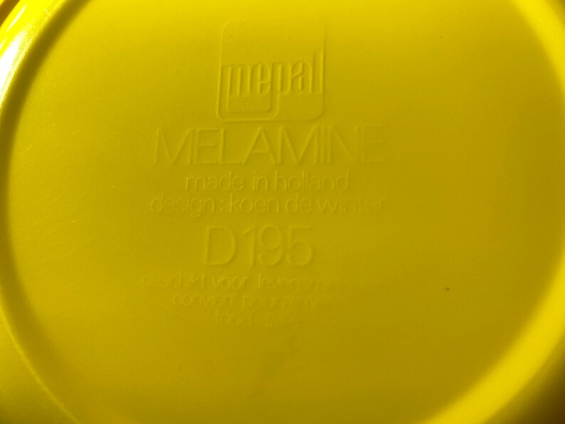 May include: Yellow melamine plate with the text "pepal MELAMINE made in holland design: koen de winter D195" printed on the bottom.