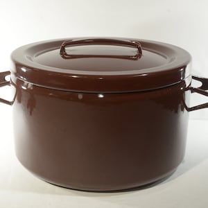 May include: A brown enamel pot with two handles and a lid. The pot has a rounded shape and a smooth surface.
