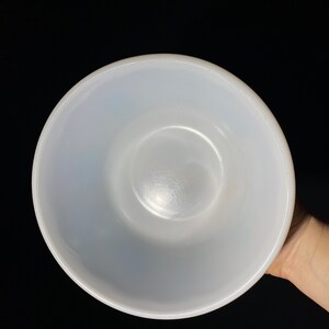 May include: A white ceramic mixing bowl with a smooth, glossy finish. The bowl is empty and appears to be in good condition.