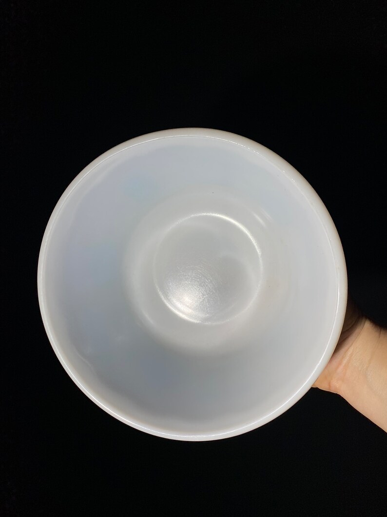 May include: A white ceramic mixing bowl with a smooth, glossy finish. The bowl is empty and appears to be in good condition.