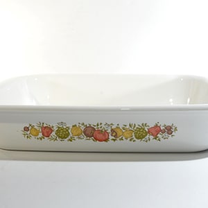 May include: White rectangular oven dish with rounded corners and a decorative band of colourful fruits and vegetables. The dish has a capacity of approximately 2.8 litres.