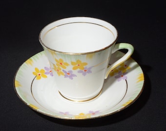 PHOENIX CHINA Floral Bone China Teacup and saucer art deco yellow purple flowers hand painted gold Rimmed England triangular handle green