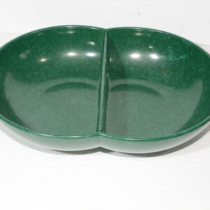 May include: A divided serving bowl made of green speckled ceramic. The bowl has a rounded shape and a smooth, glossy finish.