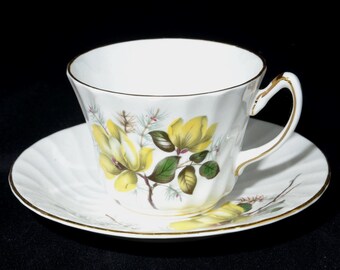 Tasse à thé plate et soucoupe Delphine, fleur de magnolia jaune, spirale florale à bordure dorée en porcelaine de Chine, fabriquée en Angleterre